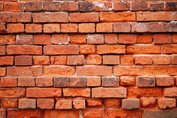 istock Texture of stones and cobblestones. Very old, crumbling brick wall 1141173717