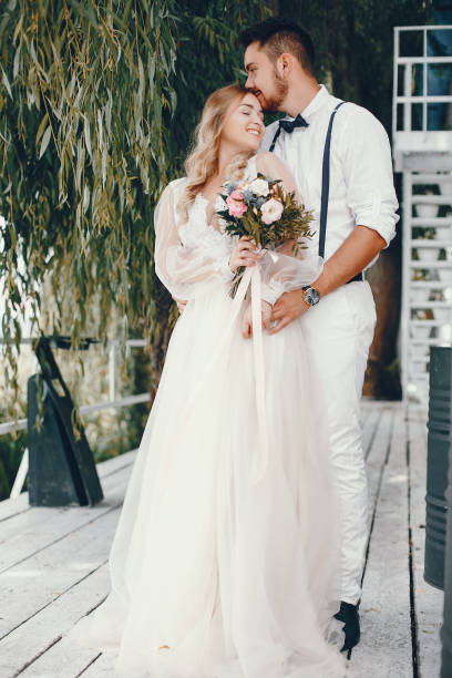 istock Beautiful bride with her husband in a park 1141176943