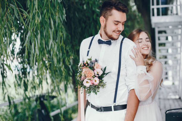 istock Beautiful bride with her husband in a park 1141177477