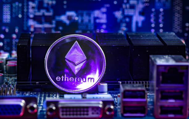 Front view of Ethereum(ETH)  cryptocurrency physical coin Front view of Ethereum(ETH) cryptocurrency painted with laser stand on computer video card.Bitcoin mining farm concept. ethereum stock pictures, royalty-free photos & images