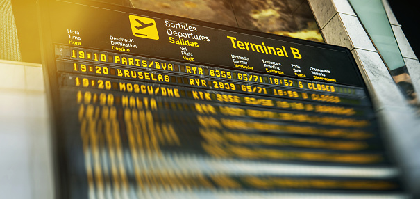 Barcelona, Spain - Jun 4, 2018: Airport departure board with schedule time and flights number of diverse international airways destination to Paris, Brussels - defocused bokeh