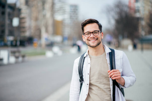 Portrait of a smiling casual man in urban background. Portrait of a smiling casual man in urban background. one young man only stock pictures, royalty-free photos & images