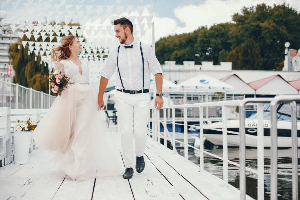 istock Beautiful bride with her husband in a park 1141180631