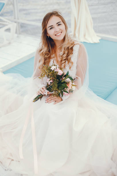 istock Beautiful bride in a long white wedding dress 1141181192