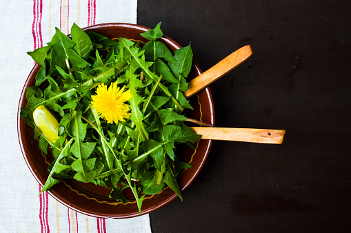 Fresh dandelion salad in a bowl top view