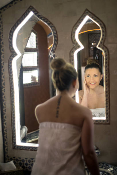 istock Beautiful woman looking in a mirror 1141182098