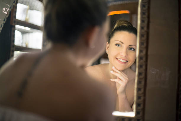 istock Beautiful woman looking in a mirror 1141182515