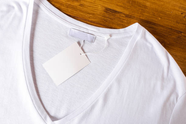istock White t-shirt on a wooden background - Image 1141183364