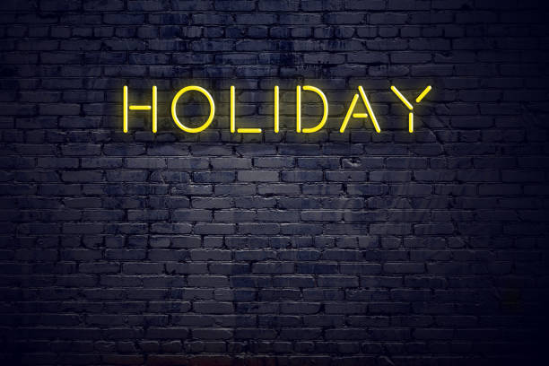 istock Night view of neon sign with text holiday 1141183376