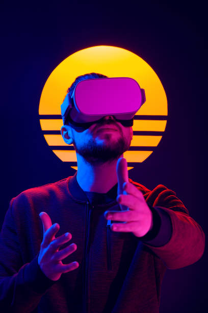 istock VR head set videogame in 80's synth wave and retro wave futuristic aesthetics. 1141184093