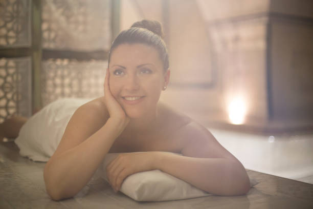 Young woman in a spa, lying on the massage table. About 25 years old, Caucasian female.