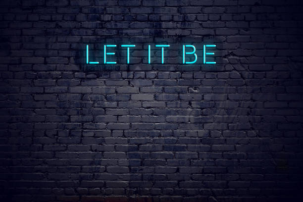 Neon sign with short motivational quote against brick wall stock photo