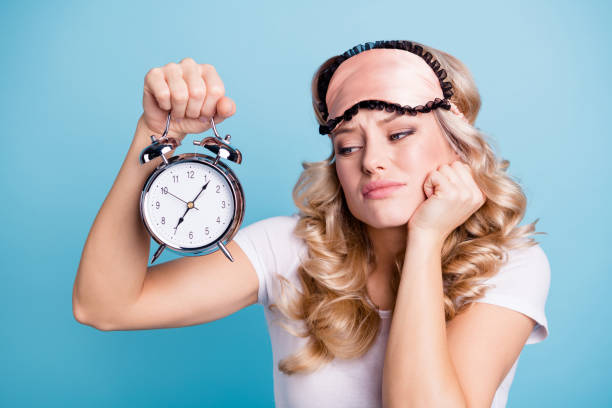 close-up portrait of her she nice lovely attractive sad wavy-haired lady holding in hand showing retro vintage clock waiting late isolated over bright vivid shine blue background - waiting women clock boredom imagens e fotografias de stock
