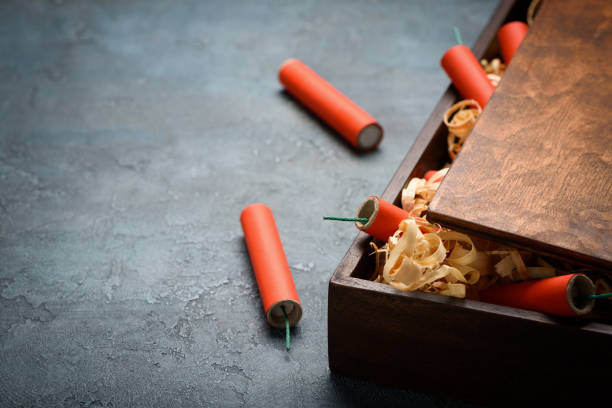 istock Red dynamite tnt firecrackers fuse in wooden box 1141185595