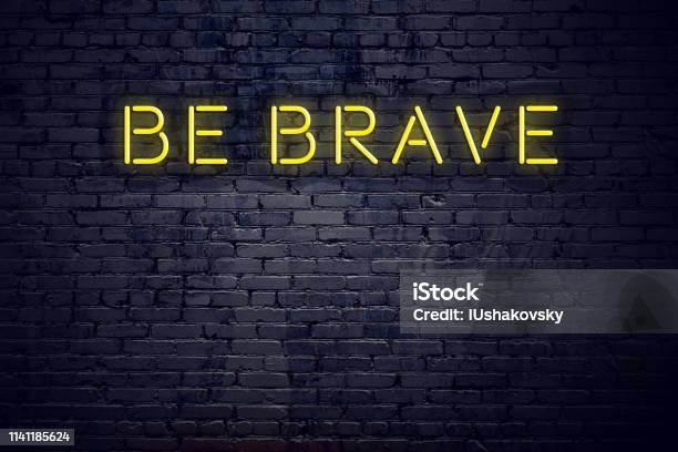 Night View Of Neon Sign With Text Be Brave Stock Photo - Download Image Now - Advice, Authority, Brick