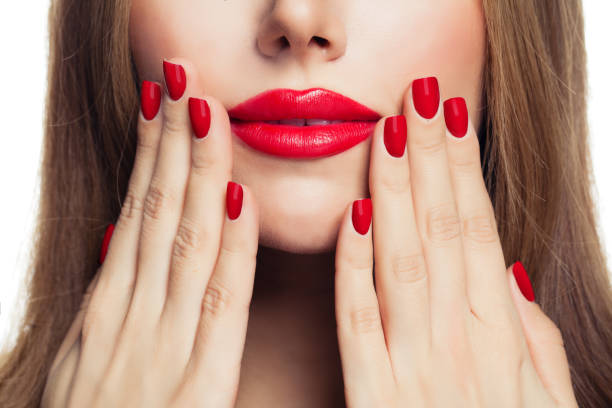 istock Red manicure nails and red female lips closeup 1141185799