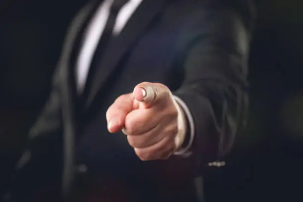 Photo of Businessman on Dark Background Pointing His Finger