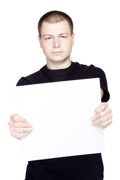istock Young man holding a blank sheet empty on white background isolated 1141187565