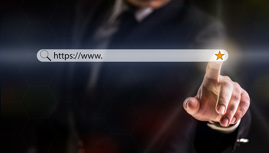 Businessman on Dark Background Touching Search or Favorite Button on Internet Browser over Virtual Screen