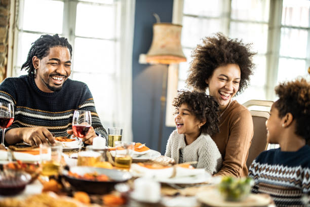 istock Happy African American talking during lunch at dining table. 1141191190