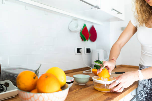 istock Woman Preparing Orange Juice in the Kitchen 1141191814