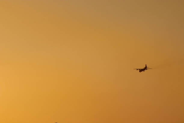 istock the plane flies high in the sky and the sun 1141193431