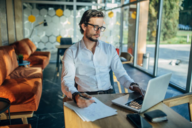 istock Handsome businessman working in cafe alone 1141197033