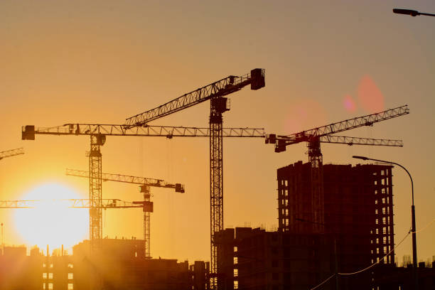 istock construction of the building cranes in the strongest light, otherwise 1141197339