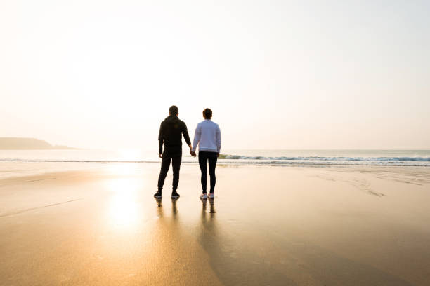 istock Couple holding hands at beach 1141197728