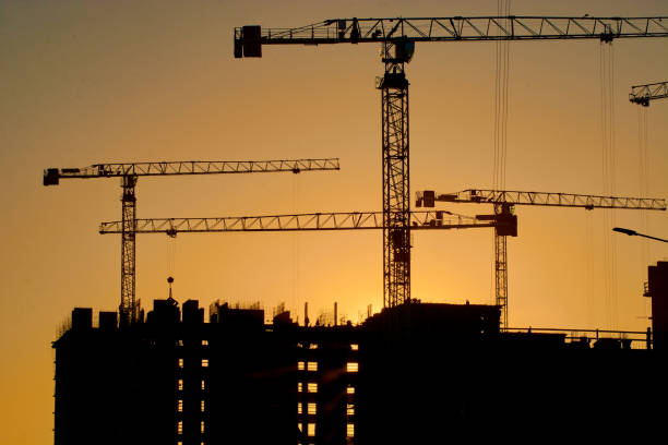istock construction of the building cranes in the strongest light, otherwise 1141197813