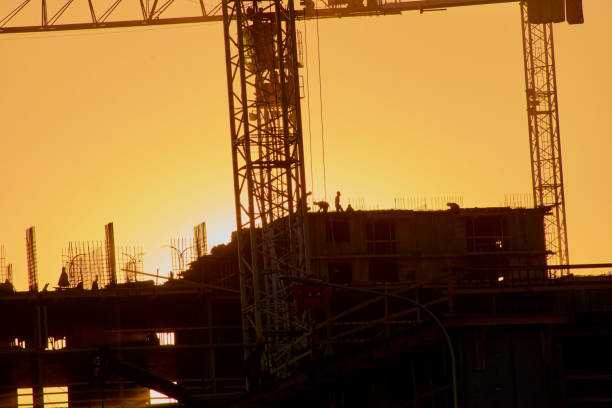 istock construction of the building cranes in the strongest light, otherwise 1141197860