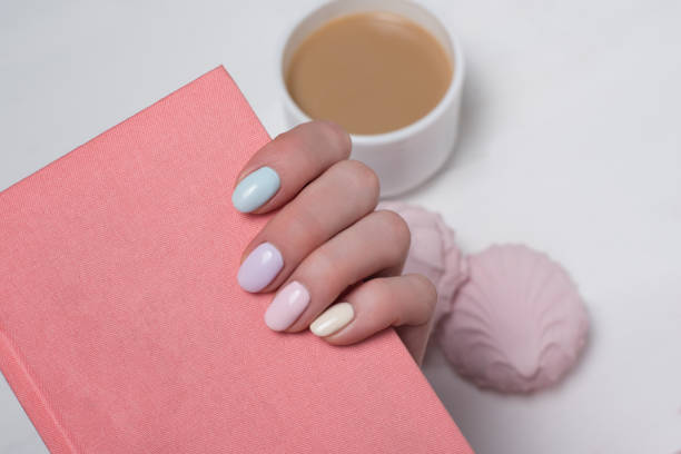istock Pink notepad in a female hand. Gentle manicure. Close-up 1141198963