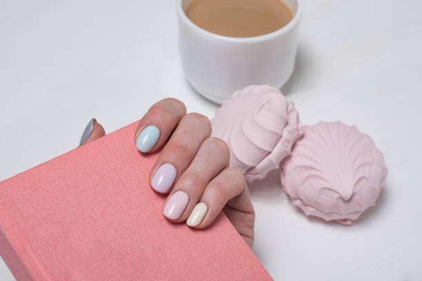 istock Pink notepad in a female hand. Gentle manicure. Close-up 1141198965