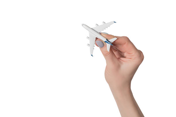 istock Passenger plane in female hand isolate on white background. Concept of safe flights 1141199039