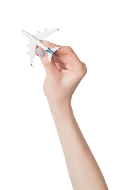 istock Passenger plane in female hand isolate on white background. Concept of safe flights 1141199044