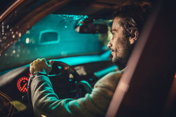 istock Gentleman driving a car on a rainy night 1141199686