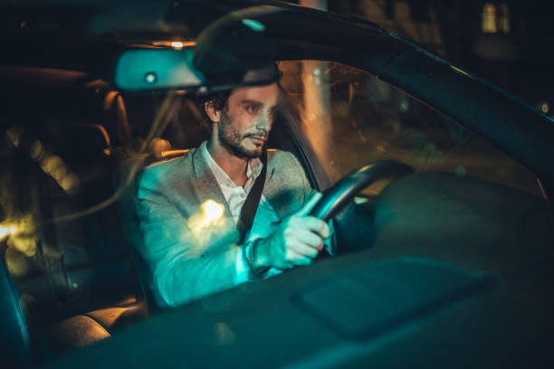 istock Handsome gentleman driving a car at night 1141200900
