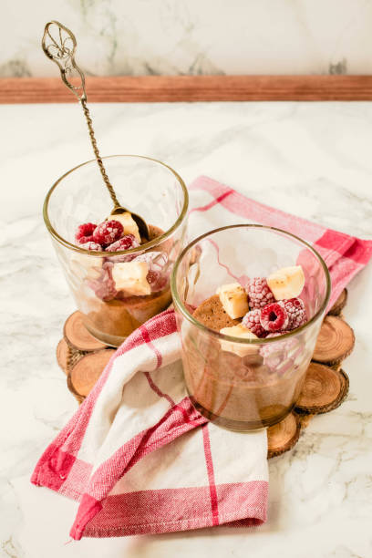 Aquafaba chocolate mousse. Light dessert with banana and berries. Vegan and vegetarian food concept stock photo