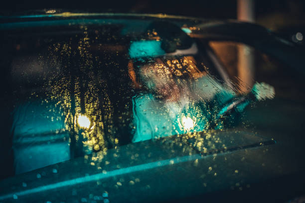 istock Man driving a car at night when it's raining 1141201269