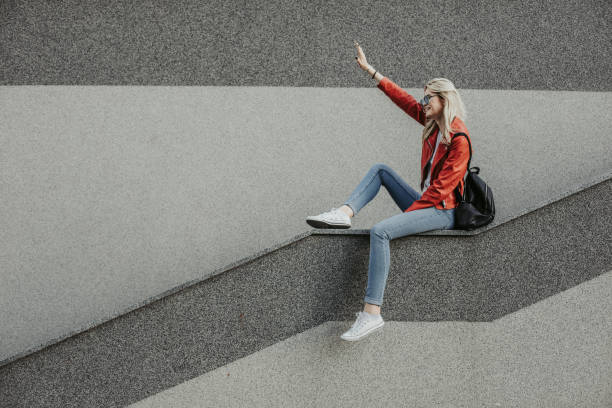Free Stock Photo of Young woman sitting on a sloped concrete wall ...