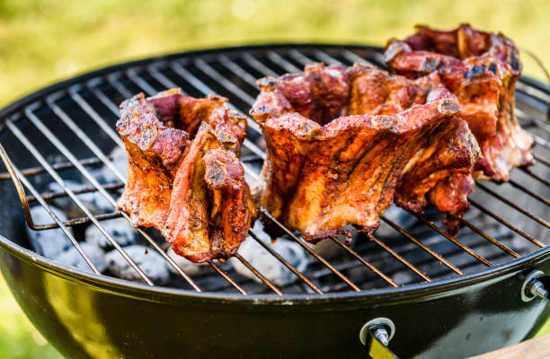 istock Baby Back Ribs Crown Roast on BBQ barbecue kettle grill. 1141201736