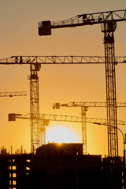 istock construction of the building cranes in the strongest light, otherwise 1141202022