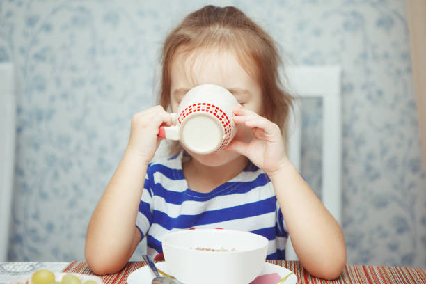 istock Little girl has her morning breakfast and drinks tea 1141203393
