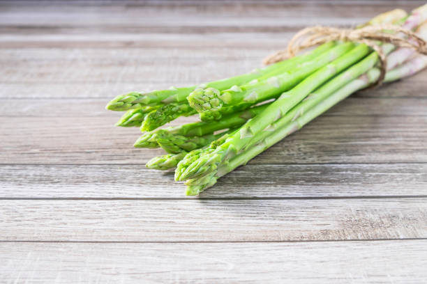 istock Fresh asparagus On a wooden background 1141204842