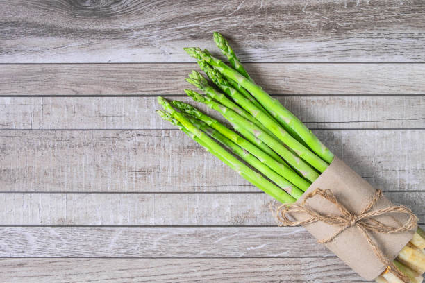 istock Fresh asparagus on wooden table 1141204860