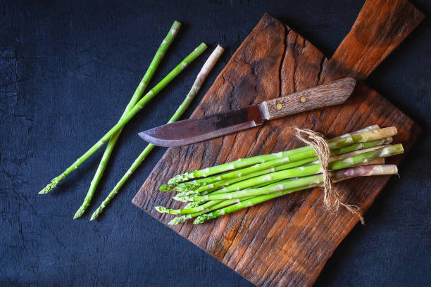 istock Asparagus on a wooden cutting board 1141204865