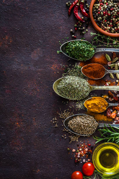 istock Spices and herbs in vintage spoons shot from above on rustic brown table 1141208073