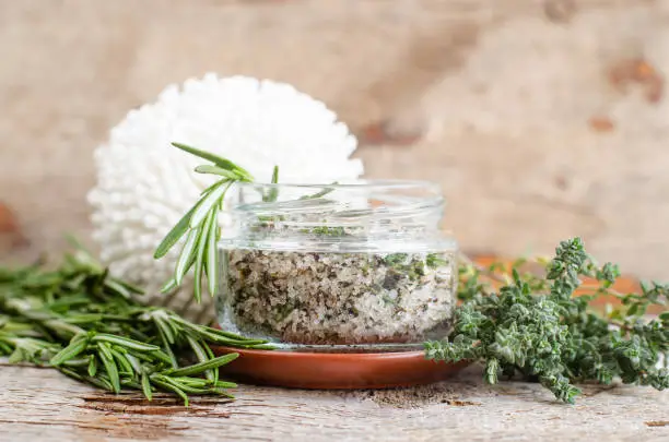 Homemade herbal scrub with rosemary, thyme,  lime juice, sea salt and olive oil. Natural skin and hair care. DIY beauty treatments and spa recipe. Copy space