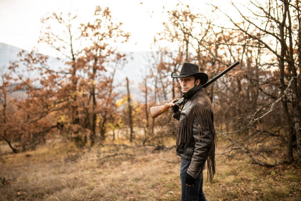 istock Hunter with rifle in woodland 1141208823