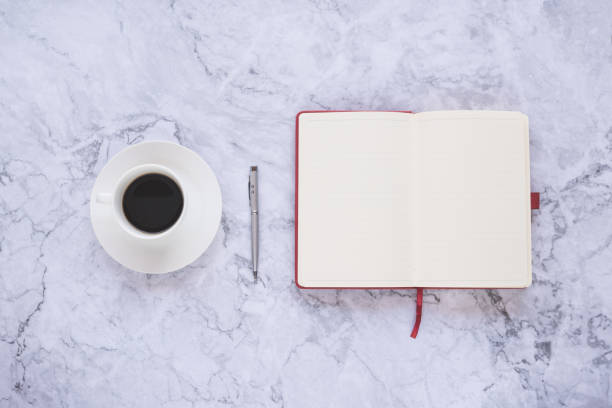 istock Flat lay creative and designer background with cup of coffee and office tools on white marble background 1141209804